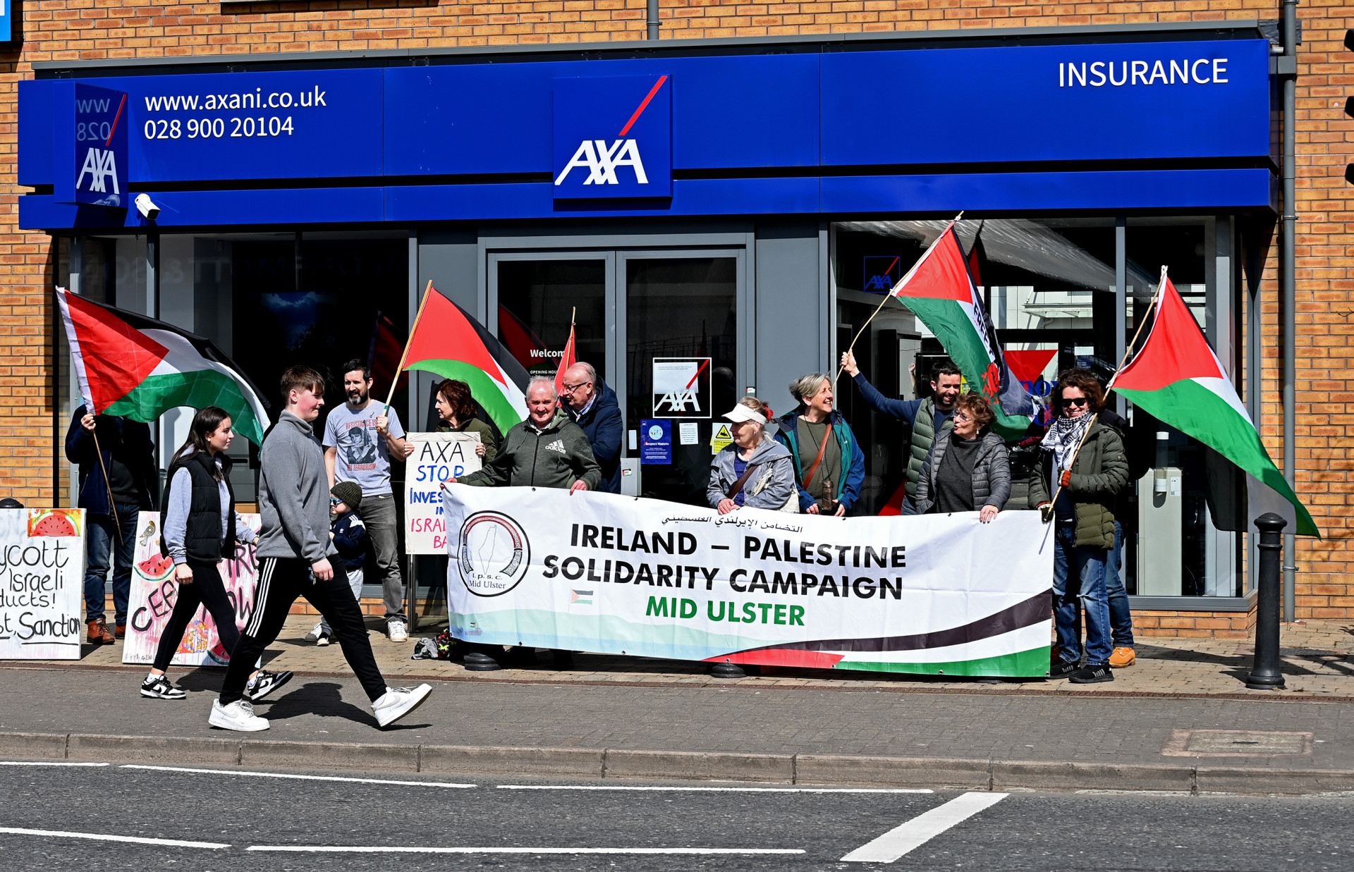 Pro-Palestine campaigners protest outside AXA branch