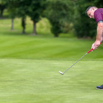 Damien Campbell strokes his putt on the 1st green.JMG8