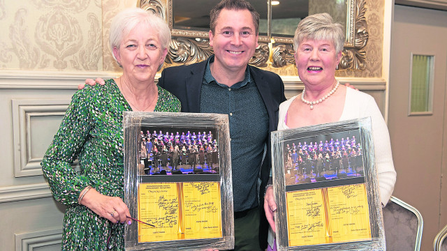 Darryl Simpson, one of the Celtic Tenors, presented both Meta Bell and Susan Stewart with framed photographs to mark their retirement from Dungannon Choral Society. IM-12